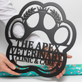 Personalized veterinary clinic metal sign with paw print in black steel