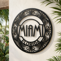 Round Miami metal sign with Art Deco buildings and palm trees in black steel