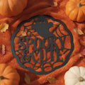 Round Halloween metal sign with cute ghost and spider web in black steel