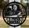 Round private property sign with man in pickup truck in black steel
